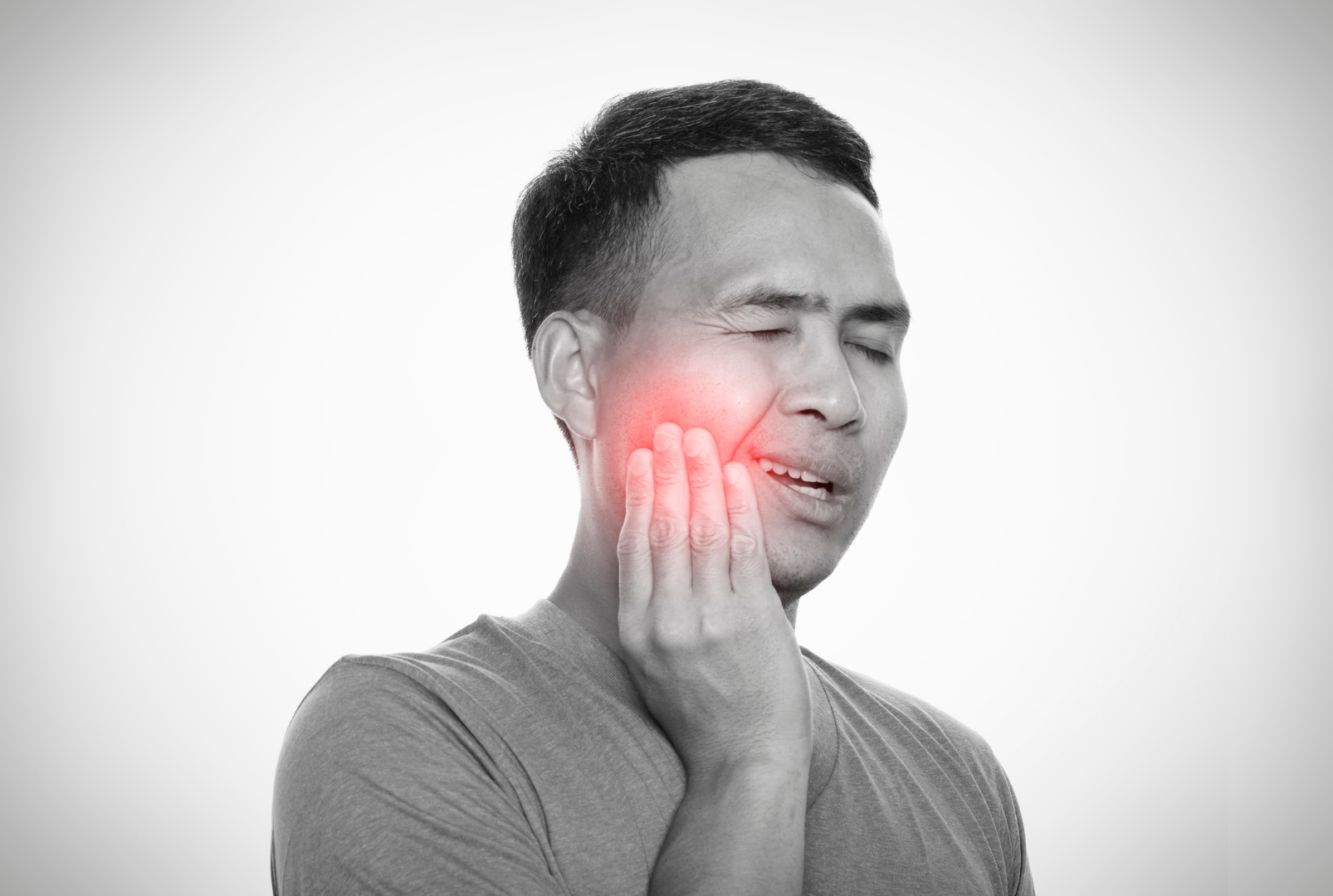 Man experiencing jaw and facial pain caused by Temporomandibular Disorder (TMD)